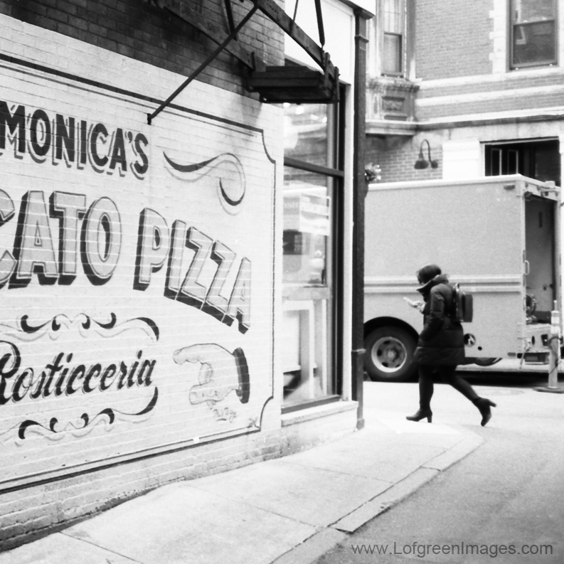 black and white street scene of Monicas pizzaria in boston ma